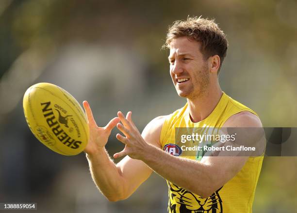 Kane Lambert of the Tigers controls the ball during a Richmond Tigers AFL training session at Punt Road Oval on April 01, 2022 in Melbourne,...