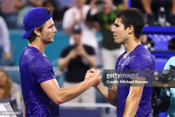 Carlos Alcaraz of Spain shakes hands with Miomir Kecmanovic of Serbia after defeating him in their Men's quarterfinal match during the Miami Open at...