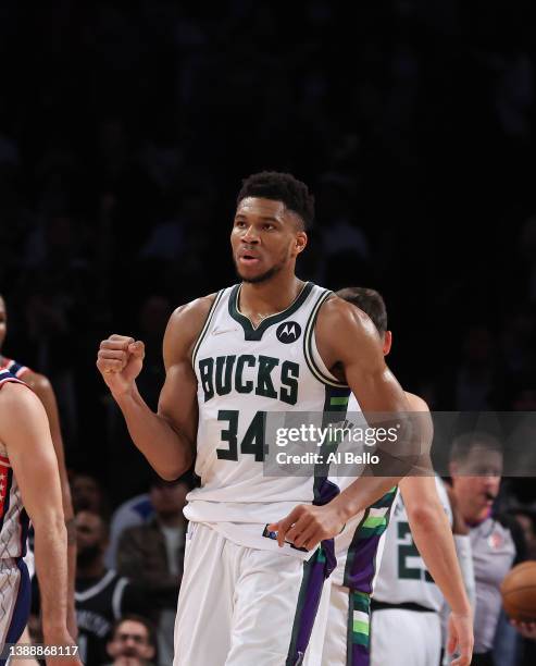 Giannis Antetokounmpo of the Milwaukee Bucks celebrates after putting his team ahead 120-119 in overtime as they defeat the Brooklyn Nets during...