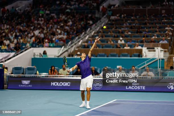 Miomir Kecmanovic of Serbia serves against Carlos Alacraz of Spain in the quarter finals of the men's singes at the Miami Open at the Hard Rock...