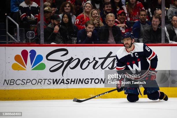 March 26: Alex Ovechkin of the Washington Capitals looks on from the ice as television personality and game show host Pat Sajak watches from the...