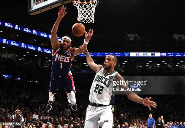 Bruce Brown of the Brooklyn Nets is fouled by Khris Middleton of the Milwaukee Bucks and was ejected from the game as a result during their game at...