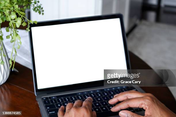 woman works from home on laptop with blank screen - blank laptop screen stock-fotos und bilder
