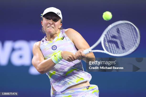 Iga Swiatek of Poland returns a shot to Jessica Pegula of the United States in their Women's Singles semifinal match during the Miami Open at Hard...