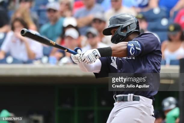 Miguel Andujar of the New York Yankees hits a single in the fourth inning against the Philadelphia Phillies during a Grapefruit League spring...