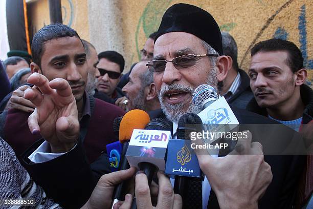 Egypt's Muslim Brotherhood leader Mohammed Badie speaks to the media outside a polling station in Beni Suef on December 15 during the second round of...