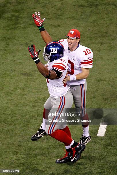 Eli Manning and Justin Tuck of the New York Giants celebrate after the Giants won 21-17 against the New England Patriots during Super Bowl XLVI at...