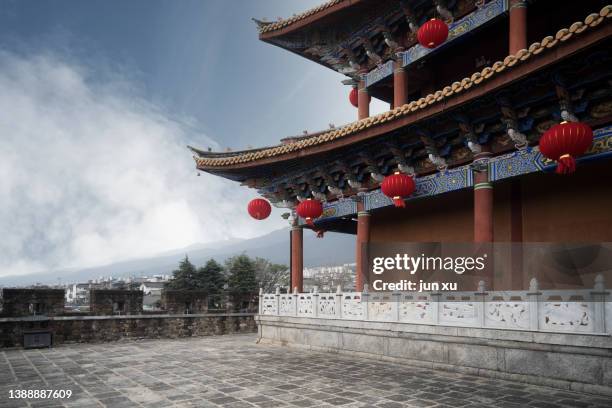 red lanterns hanging from beams of ancient buildings - chinese lanterns stock pictures, royalty-free photos & images