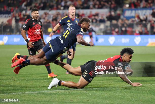 Leicester Fainga'anuku from the Crusaders dives over to score a try as Mosese Dawai from the Highlanders arrives too late during the round seven...