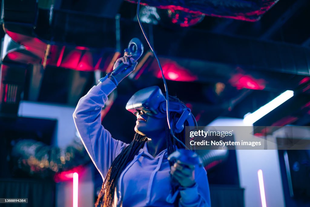 Young woman playing VR video game