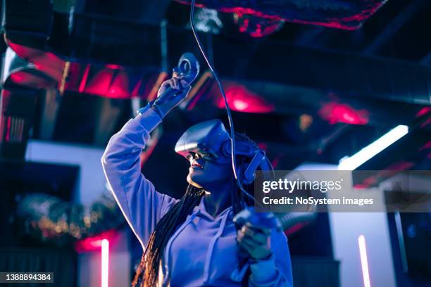 young woman playing vr video game - esports stock pictures, royalty-free photos & images