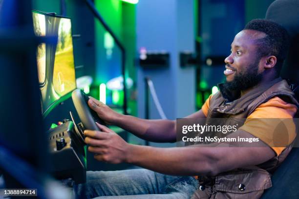 young man play car racing online video games - car racing game stock pictures, royalty-free photos & images