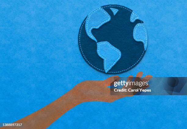 paper work human hand holding a planet earth globe - earthday foto e immagini stock