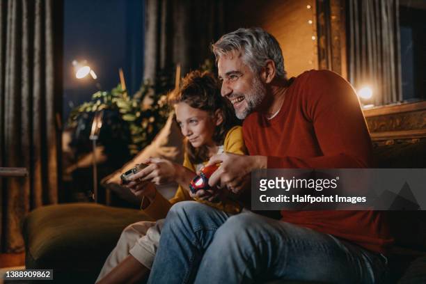 family playing video games. family bonding activities. - games console stock-fotos und bilder