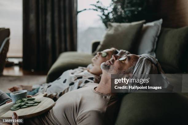 father and teen daughter applying face mask together at home. - home stock-fotos und bilder