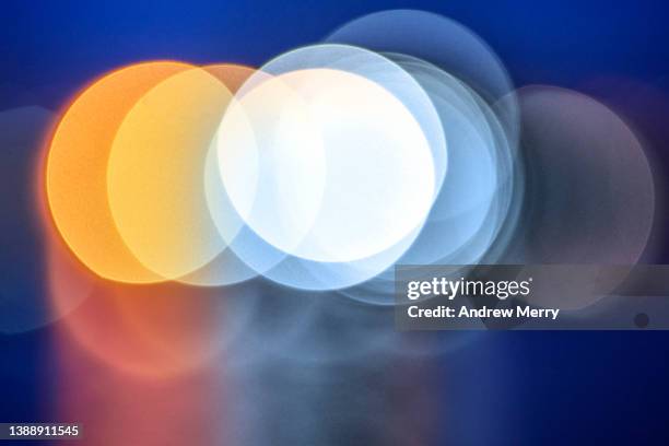 night abstract circles orange white blue lens blurred - visual stock pictures, royalty-free photos & images