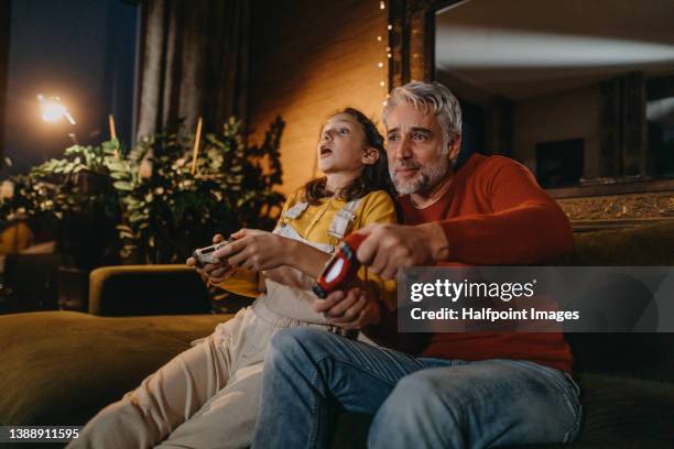 family playing video games. family bonding activities. - family game night stock pictures, royalty-free photos & images