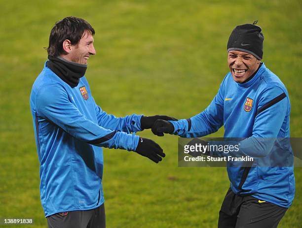 Lionel Messi and Adriano of FC Barcelona joke around during training at the BayArena on February 13, 2012 in Leverkusen, Germany.