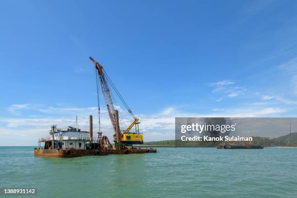a crane vessel, crane ship or floating crane barge in the sea - dredger stock pictures, royalty-free photos & images
