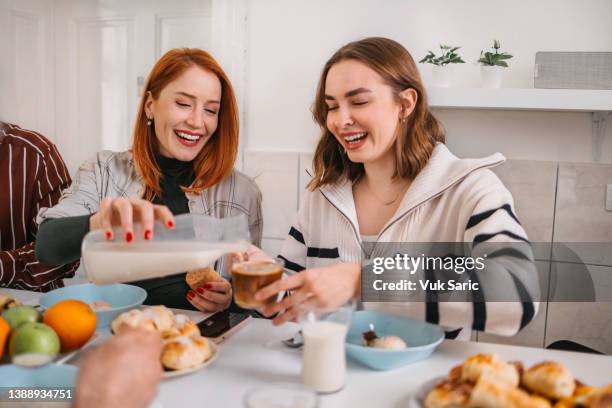 coworkers pouring almond milk into coffee - almond milk stock pictures, royalty-free photos & images