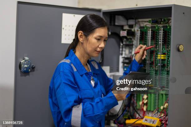 it technician using digital tablet in server room. - electrical switchboard stock pictures, royalty-free photos & images