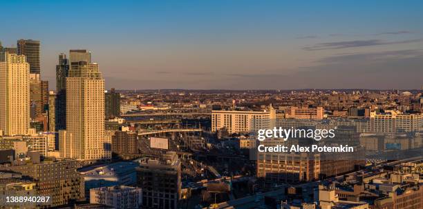 aerial view of the business district surrounded by the low-level residential area, in long island city, queens, new york, in the evening. high-resolution stitched panorama. - skyline stitched composition stock pictures, royalty-free photos & images