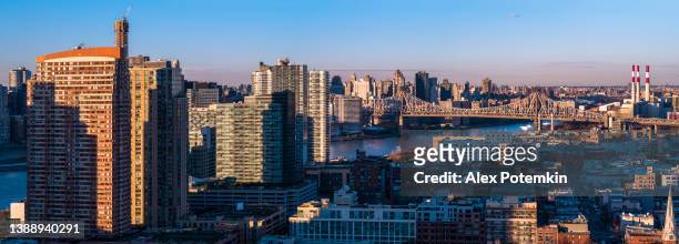 aerial view of long island city, over the residential district to queensboro bridge and roosevelt island. extra-large high-resolution stitched panorama. - skyline stitched composition stock pictures, royalty-free photos & images