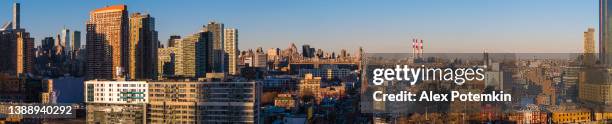 aerial view of long island city, over the residential district to queensboro bridge and roosevelt island. extra-large high-resolution stitched panorama. - skyline stitched composition stock pictures, royalty-free photos & images