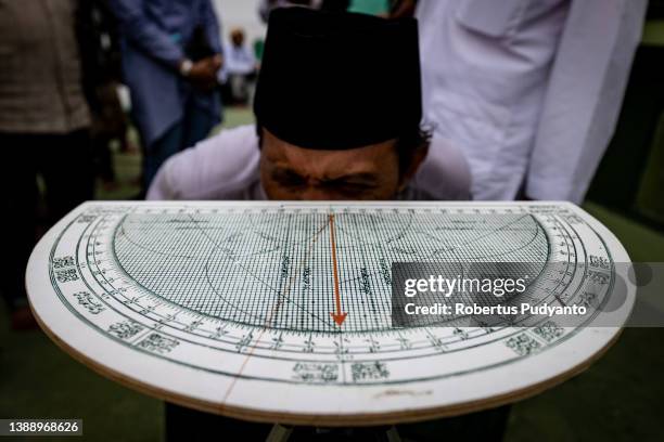 An Indonesian Muslim performs a Rukyatul Hilal to observe the new crescent moon, which determines the start of Ramadan at Al-Mabrur mosque on April...