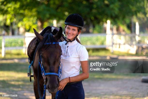 a portrait of young woman with equestrian helmet - hobby horse stock pictures, royalty-free photos & images