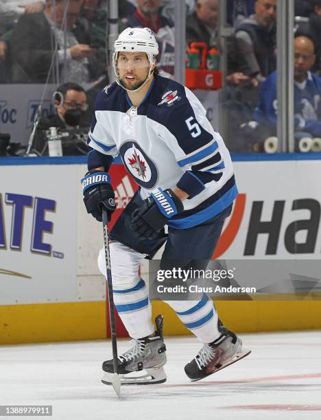 Brenden Dillon of the Winnipeg Jets skates against the Toronto Maple Leafs during an NHL game at Scotiabank Arena on March 31, 2022 in Toronto,...