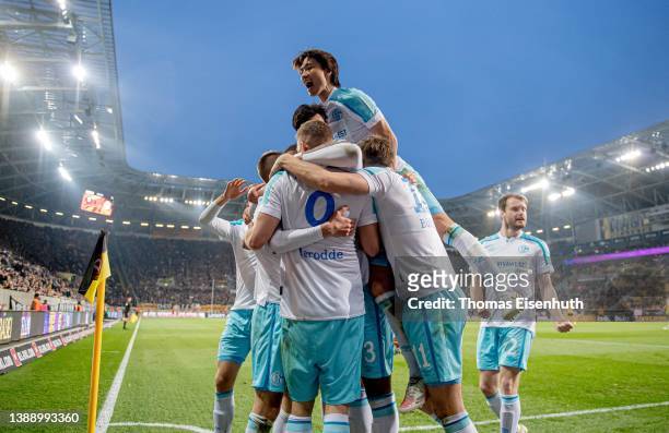 Simon Terodde of Schalke celebrates with teammates after scoring his team's seond goal during the Second Bundesliga match between SG Dynamo Dresden...