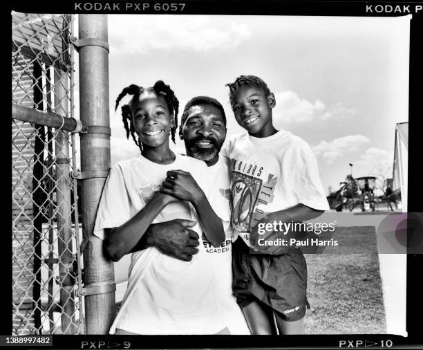 Venus Williams With Her Father/Coach Richard Williams And Her Sister Serena pose for a portrait at their local tennis court in Compton, California on...