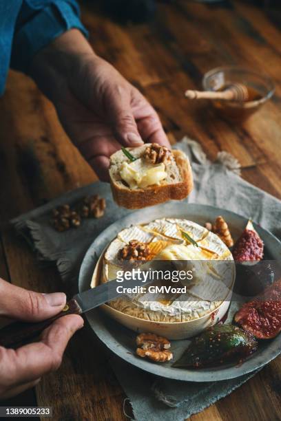 baked camembert cheese with fresh figs - brie stock pictures, royalty-free photos & images