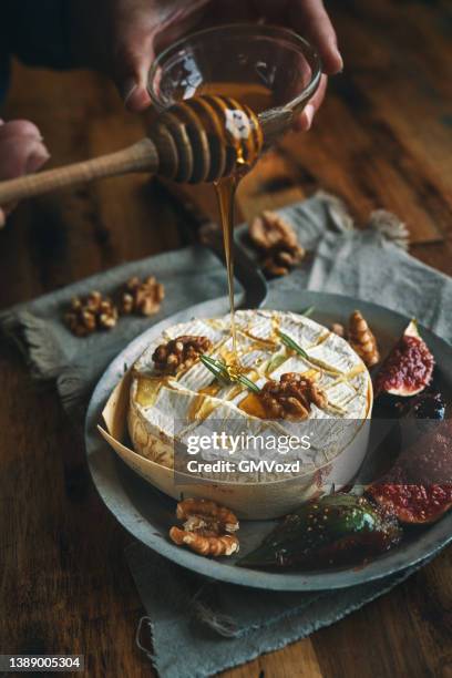 baked camembert cheese with fresh figs - baked brie stock pictures, royalty-free photos & images