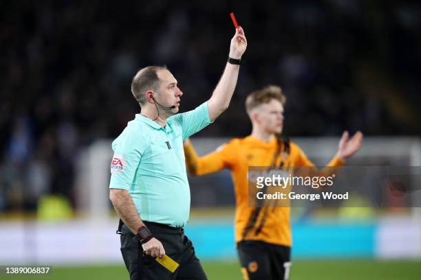 Tom Eaves of Hull City is shown a red card by referee Jeremy Simpson during the Sky Bet Championship match between Hull City and Huddersfield Town at...