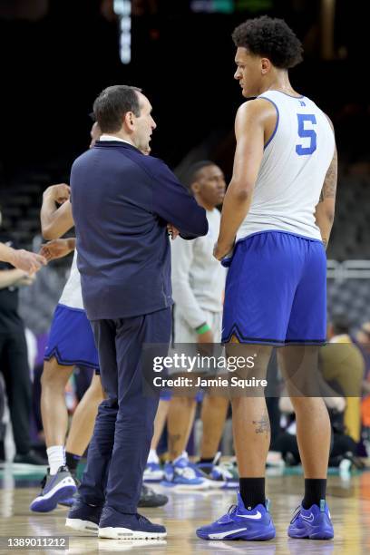 Head coach Mike Krzyzewski of the Duke Blue Devils talks to player Paolo Banchero during practice before the 2022 Men's Basketball Tournament Final...