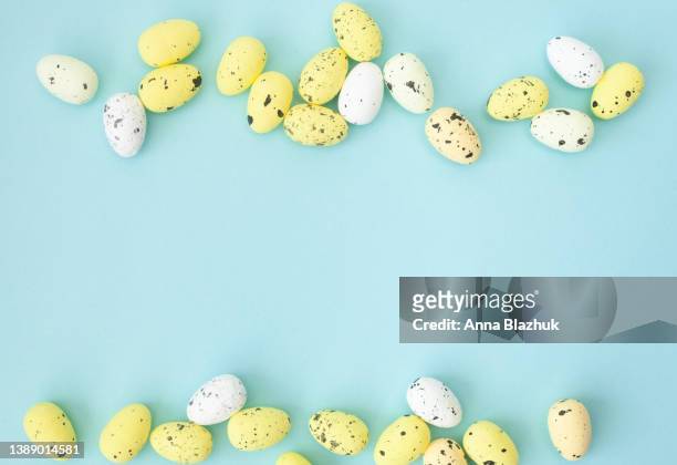 colorful yellow easter eggs over blue background. greeting card for holidays. - easter religious background stock pictures, royalty-free photos & images