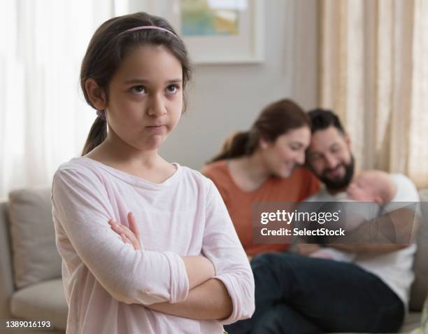 little girl jealous of her baby brother - jealous child stock pictures, royalty-free photos & images