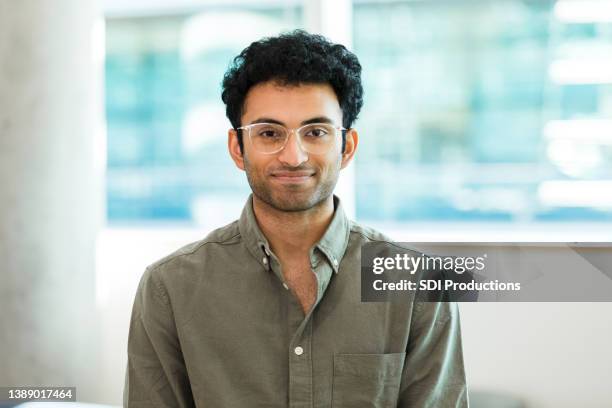 man wearing button down shirt and eyeglasses poses for photo - male medical student stock pictures, royalty-free photos & images