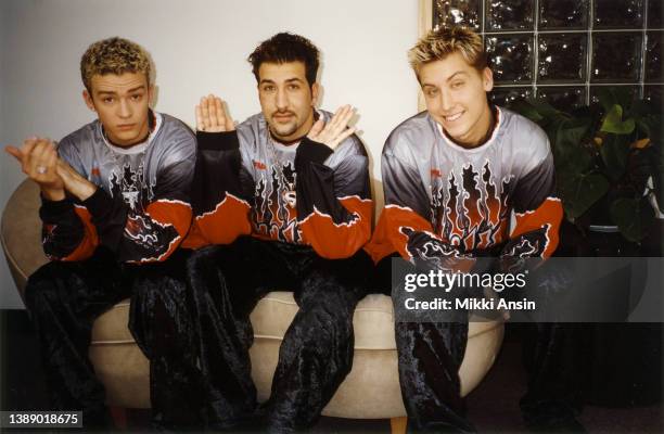 View of, from left, American Pop singers Justin Timberlake, Joey Fatone, and Lance Bass, all of the group N'Sync, pose in matching outfits, Boston,...