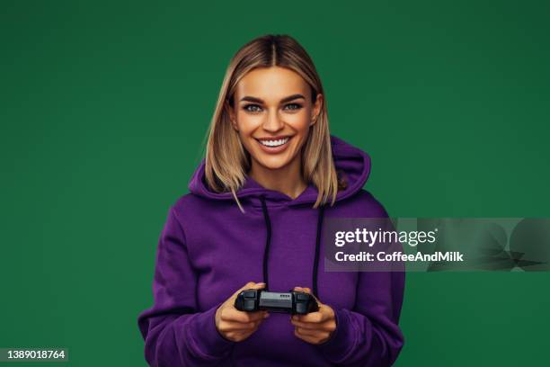 woman holding joystick and playing - gamers stockfoto's en -beelden