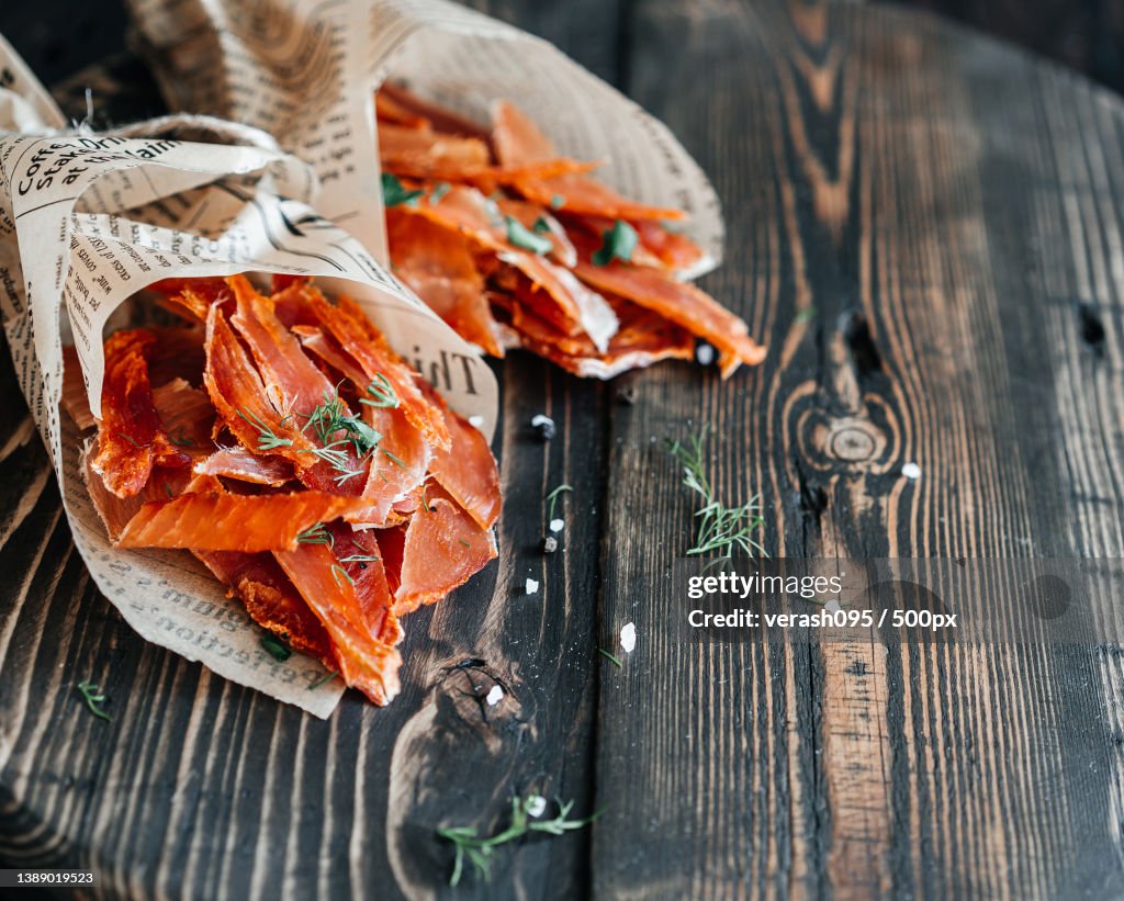 Dried chicken in bags on a wooden board close-up