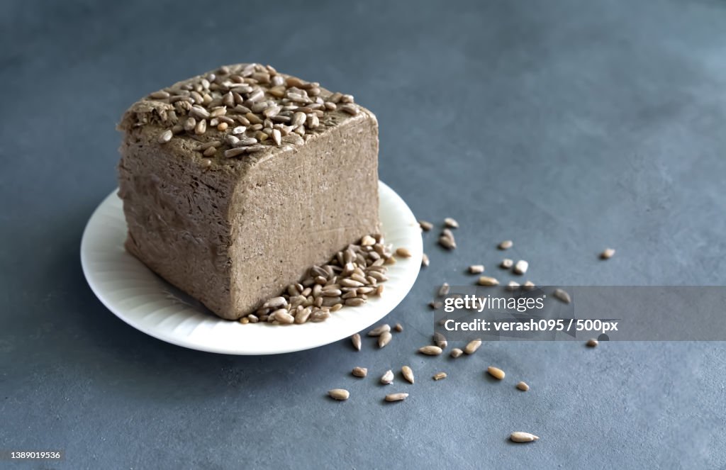 Halva from sunflower seeds on a white plate with seeds