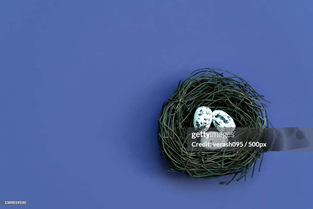 Blue Easter eggs and bouquet of flowers on rustic table wood