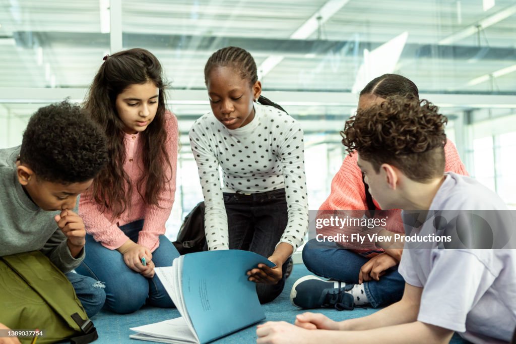 Tween students working on group assignment at school