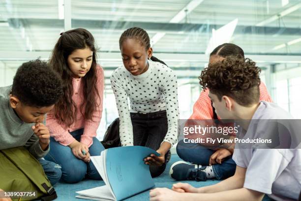 tween students working on group assignment at school - kids group stock pictures, royalty-free photos & images