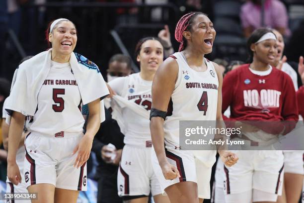 Aliyah Boston and Victaria Saxton of the South Carolina Gamecocks celebrate with teammates in the second half against the Louisville Cardinals during...