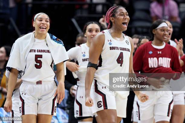 Victaria Saxton and Aliyah Boston of the South Carolina Gamecocks celebrate with teammates in the second half against the Louisville Cardinals during...