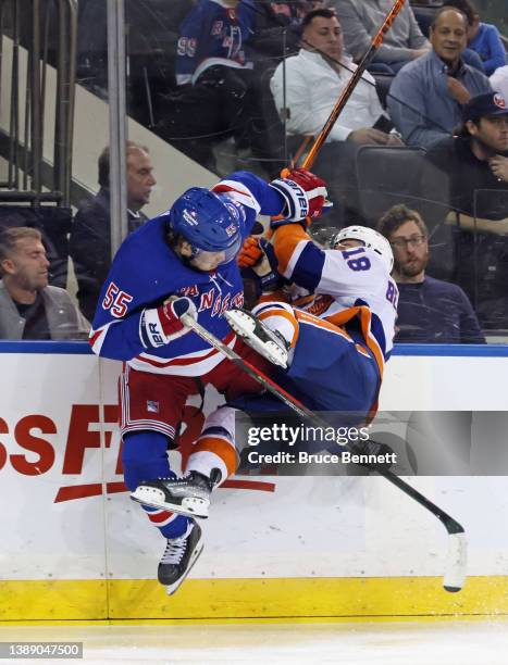 Ryan Lindgren of the New York Rangers checks Anthony Beauvillier of the New York Islanders during the third period at Madison Square Garden on April...